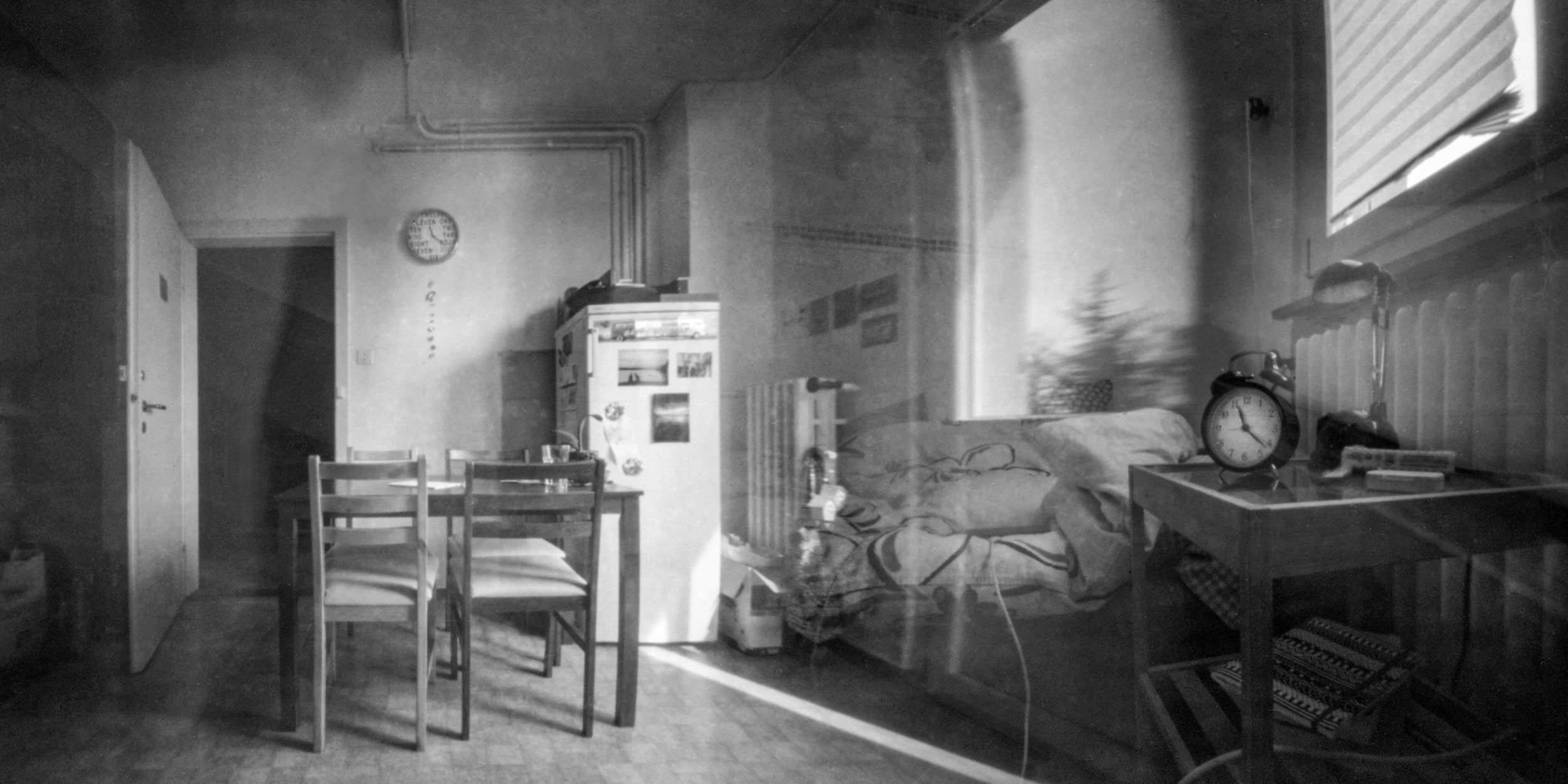Lochkamera-Bild: ein leerer Raum mit Stühlen und einer Uhr